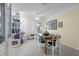 Bright dining room with white chairs, ceiling fan, and access to the outdoors at 101 Lakeshore Blvd, St Cloud, FL 34769