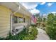 Charming front porch with American flag and lush landscaping, welcoming you to this lovely home at 101 Lakeshore Blvd, St Cloud, FL 34769