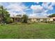 Inviting yellow home with lush landscaping and charming gazebo, perfect for outdoor entertaining at 101 Lakeshore Blvd, St Cloud, FL 34769