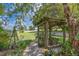 Tranquil gazebo adorned with plants and a hanging swing, offering a peaceful backyard retreat at 101 Lakeshore Blvd, St Cloud, FL 34769