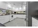 Bright kitchen features white cabinets, black countertops, and stainless steel appliances at 101 Lakeshore Blvd, St Cloud, FL 34769