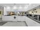 Bright kitchen features white cabinets, black countertops, and stainless steel appliances at 101 Lakeshore Blvd, St Cloud, FL 34769