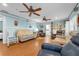 Open living room area with wood floors, ceiling fans, and views to other rooms in the home at 101 Lakeshore Blvd, St Cloud, FL 34769