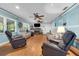Spacious living room features a brick fireplace, hardwood flooring and an abundance of seating at 101 Lakeshore Blvd, St Cloud, FL 34769