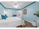Bright bedroom features blue walls, white trim and a large white bed at 101 Lakeshore Blvd, St Cloud, FL 34769