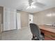 Room with paneled wall, ceiling fan, and view into the hallway at 101 Lakeshore Blvd, St Cloud, FL 34769