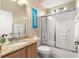 Bright bathroom with granite countertop, tiled shower, and decorative accent at 1010 Sierra Blanca Ct, Lady Lake, FL 32159