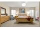 Serene bedroom with a decorative chandelier, ample natural light, and neutral décor at 1010 Sierra Blanca Ct, Lady Lake, FL 32159