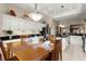 Open-concept dining area with white cabinets, pendant lighting, and a well-set wooden table and chairs at 1010 Sierra Blanca Ct, Lady Lake, FL 32159