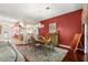 Comfortable dining room highlighted by a wooden table and chairs, vibrant accent wall, and elegant decor at 1010 Sierra Blanca Ct, Lady Lake, FL 32159
