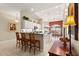 Open concept kitchen with an island, bar-style seating, white cabinetry, and plenty of natural light at 1010 Sierra Blanca Ct, Lady Lake, FL 32159