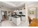 Kitchen showcasing black countertops, stainless steel appliances, a central island, and bright recessed lighting at 1010 Sierra Blanca Ct, Lady Lake, FL 32159