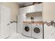 Bright laundry room with washer and dryer, and plenty of cabinet space at 1010 Sierra Blanca Ct, Lady Lake, FL 32159