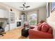 Cozy living room with hardwood floors, custom built-ins, and large window at 1010 Sierra Blanca Ct, Lady Lake, FL 32159