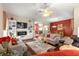 Spacious living room with modern fireplace, built-in shelving, and an open layout that flows to the dining area at 1010 Sierra Blanca Ct, Lady Lake, FL 32159