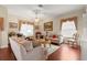 Inviting living room features a ceiling fan, wood floors, and comfortable seating, creating a cozy atmosphere at 1010 Sierra Blanca Ct, Lady Lake, FL 32159