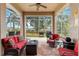 Relaxing screened patio with comfortable seating and views of the backyard and mature trees at 1010 Sierra Blanca Ct, Lady Lake, FL 32159