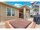 Back patio featuring a hot tub, seating, and grill, creating a relaxing outdoor space at 1010 Sierra Blanca Ct, Lady Lake, FL 32159
