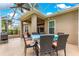 Covered patio with a dining table, perfect for outdoor meals and enjoying the serene backyard at 1010 Sierra Blanca Ct, Lady Lake, FL 32159