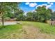 Expansive backyard with a basketball court and lush lawn offers ample space for recreation at 107 Wekiva Pointe Cir, Apopka, FL 32712