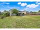 Extensive backyard with patio area, basketball court, and mature trees that provide shade and privacy at 107 Wekiva Pointe Cir, Apopka, FL 32712