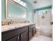 Bright bathroom with dual vanity, granite countertops, and a shower-tub combo at 107 Wekiva Pointe Cir, Apopka, FL 32712