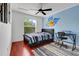 Bedroom featuring hardwood floors, a blue accent wall, and a themed decor at 107 Wekiva Pointe Cir, Apopka, FL 32712