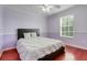 Bedroom featuring hardwood floors, natural light, and a calm, clean aesthetic at 107 Wekiva Pointe Cir, Apopka, FL 32712