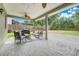 Relaxing covered patio with ceiling fans and ample seating, perfect for outdoor entertaining at 107 Wekiva Pointe Cir, Apopka, FL 32712