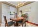 Bright dining room featuring a unique wood table, chandelier, and decorative accents at 107 Wekiva Pointe Cir, Apopka, FL 32712