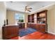 A well-lit home office with hardwood floors, a ceiling fan, and plenty of built-in storage at 107 Wekiva Pointe Cir, Apopka, FL 32712