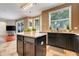 Bright eat-in kitchen with granite countertops, dark cabinetry, and views of the backyard at 107 Wekiva Pointe Cir, Apopka, FL 32712