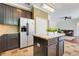 Modern kitchen with stainless steel appliances, center island, and easy access to the living area at 107 Wekiva Pointe Cir, Apopka, FL 32712