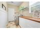 Efficient laundry room with tile floors, front-load washer/dryer and plenty of storage and counter space at 107 Wekiva Pointe Cir, Apopka, FL 32712