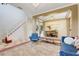 Elegant open-concept living space with staircase, dining area, and stylish furnishings at 107 Wekiva Pointe Cir, Apopka, FL 32712