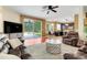 Open-concept living room with hardwood floors, leading to the backyard and a modern kitchen at 107 Wekiva Pointe Cir, Apopka, FL 32712