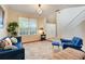 Bright living room with large windows, hardwood floors, and stylish decor at 107 Wekiva Pointe Cir, Apopka, FL 32712