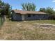 View of the backyard, showing the yard and the exterior of the house at 1109 Willow Ct, Tavares, FL 32778