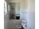 Bathroom featuring marble countertop, white fixtures and a large mirror at 1109 Willow Ct, Tavares, FL 32778