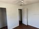 Bedroom with hardwood floors featuring closet space and natural lighting at 1109 Willow Ct, Tavares, FL 32778