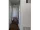 Hallway with wood-look flooring and white painted walls at 1109 Willow Ct, Tavares, FL 32778