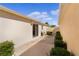 Exterior backyard with a sliding glass door, patio, and manicured hedges at 1116 San Bernardo Rd, The Villages, FL 32162