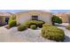 Well-manicured front yard with white rock and mature shrubbery near the façade of the home at 1116 San Bernardo Rd, The Villages, FL 32162