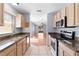 Open kitchen with stainless steel appliances and view to living area at 1116 San Bernardo Rd, The Villages, FL 32162