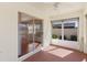 Enclosed lanai with a ceiling fan, sliding glass door, and neutral decor at 1116 San Bernardo Rd, The Villages, FL 32162