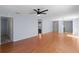 Hardwood floors span the living area, which features a ceiling fan, light fixture, and open doorway at 1116 San Bernardo Rd, The Villages, FL 32162