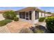 A home's screened-in lanai and outdoor patio are surrounded by lush landscaping at 1116 San Bernardo Rd, The Villages, FL 32162
