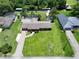 Aerial view of the home displaying the spacious yard, pool, and lush surroundings at 11418 Lake Eustis Dr, Leesburg, FL 34788
