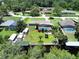 Aerial view showcasing the property's pool, waterfront location, and neighborhood at 11418 Lake Eustis Dr, Leesburg, FL 34788