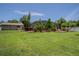 A backyard with a pool, landscaping, and grass at 11418 Lake Eustis Dr, Leesburg, FL 34788
